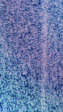 Blue and pink static shimmers across a vertical pixel screen