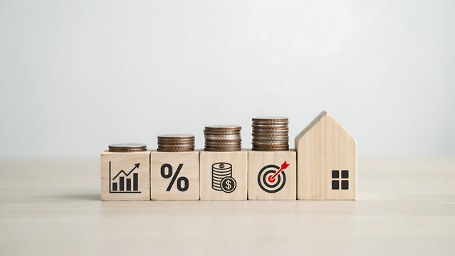 Wooden blocks with financial icons and stacked coins leading to a house financial growth percentage sign