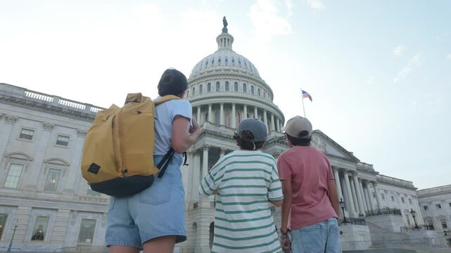 Mother and sons admiring the united states capitol building in washington d.C., a significant landmark and popular tourist destination for families visiting the capital city