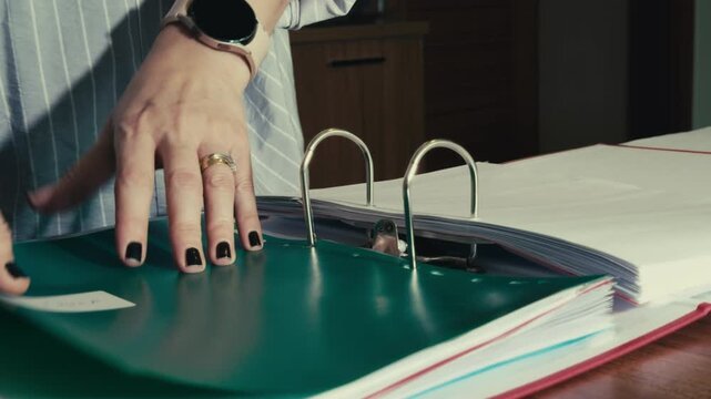 Female Employee Organizing Paperwork in Corporate Archive