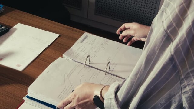Female Employee Organizing Paperwork in Corporate Archive