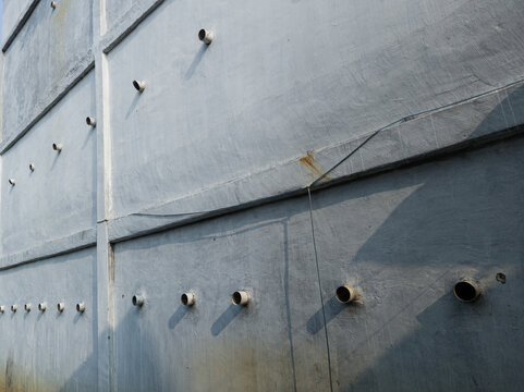 Close-up of ventilation system pipes on concrete wall of a swiftlet farm house.