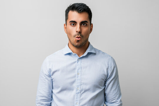 Man young casual clothes face of surprise, shocked expression and shock, excited, fear and afraid emotions &mdash; studio portrait capturing astonished reaction