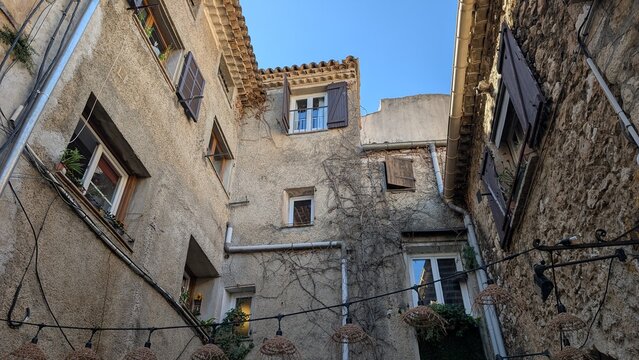 Historic stone houses with wooden shutters in Saint Paul de Vence, France. 