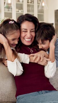 Happy, mother and hug in home with children, connection and family love bonding together on weekend. Woman, kids and embrace in living room with security, affection and quality time for wellness.