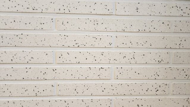brick, terrazzo-patterned brick texture, elongated bricks in a light off-white tone, interior wall, interior material, texture, background, wallpaper