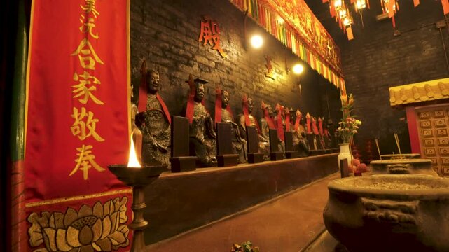 Interior of Man Mo Temple, Hong Kong: illuminated shrine with statues and lanterns.