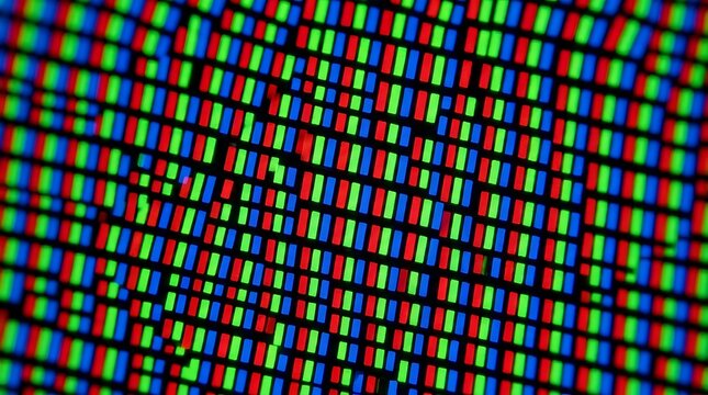 Extreme macro view showing glowing red green and blue pixels