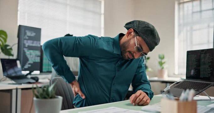 Programmer, computer and back pain in office with burnout, tired or bad posture of software engineer. Male person, technology and coworking at workplace with sore muscle. exhausted or coding job