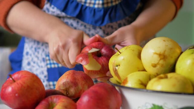 Slicing Skin Off Ripe Red Organic Apple with Small Knife for Homemade Pastry