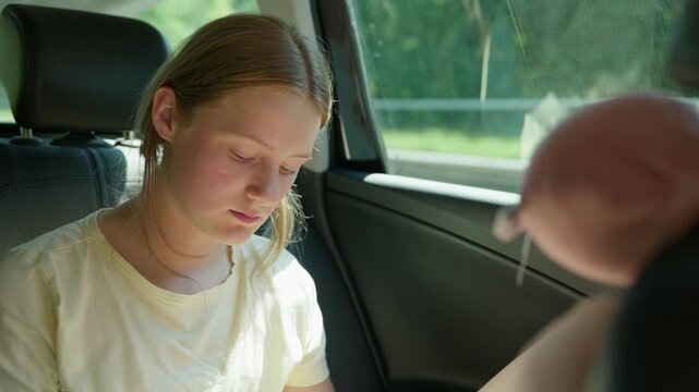 A tired and upset girl in the back seat of a car slow motion a red face from the heat