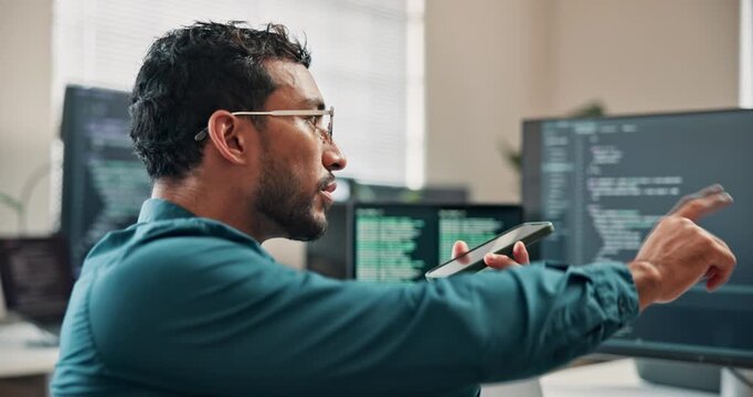 Phone, loud speaker and man with computer screen in office, software development or point at project. Programmer, online and person with mobile, voice note and communication with contact in business