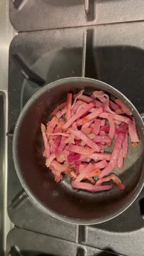 italian guanciale frying in a pan