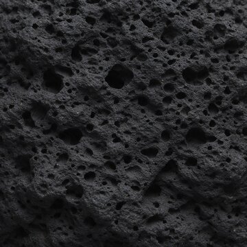 Dark volcanic rock texture with porous mineral structure