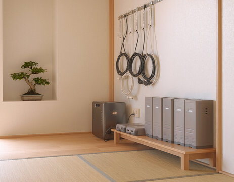 和室に整然と並ぶ電子機器と壁掛けケーブル