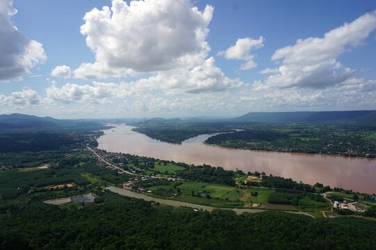 A breathtaking high-angle view overlooking the winding Mekong River from the famous viewpoint of Wat Pha Tak Suea in Sang Khom, Nong Khai, Thailand.