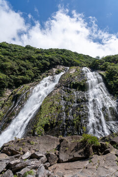 Full Vertical Vista of Oko Waterfall Under Summer Sky