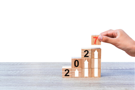 Laying wooden blocks as steps, isolated on white background. Business concept for successful growth process in 2027. 