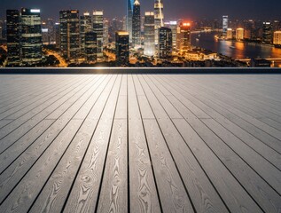 Fototapeta premium Modern wooden terrace overlooks bright city skyline at night. Urban cityscape with glowing skyscrapers, river lights background. Empty deck with grey planks provides copy space for business lifestyle