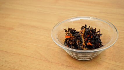Simmered hijiki seaweed in a glass bowl © takayuki