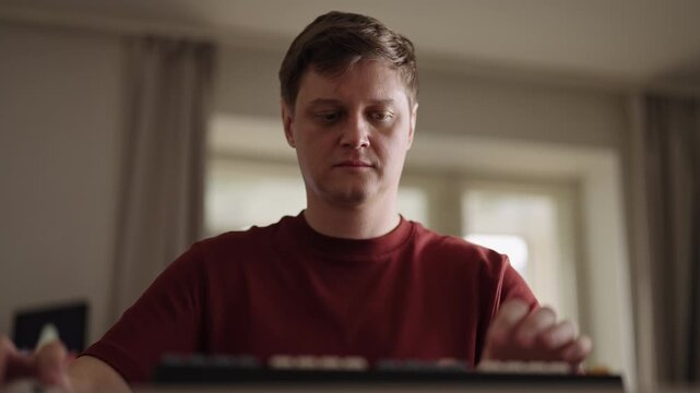 Overworked programmer furiously typing on keyboard, experiencing stress and frustration with difficult task, angry expression revealing exhaustion and creative crisis, low-angle view, slow motion.