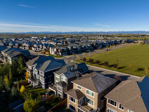 Suburban homes in Calgary looking out to the Rocky Mountains in the distance.