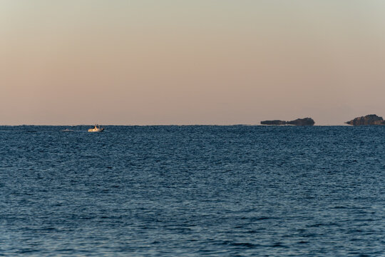 Superior mirage and floating island phenomenon over the calm ocean horizon at dusk in Wakayama Japan