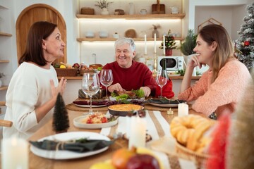 Happy family having Christmas dinner together at home kitchen
