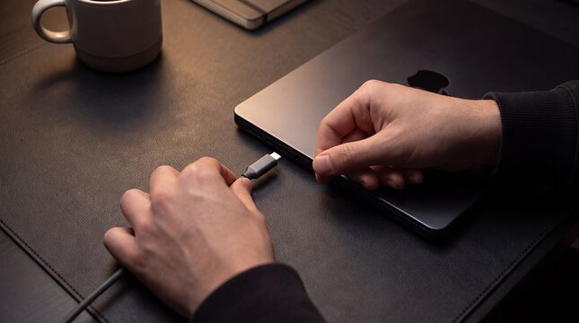 Connecting USB-C Cable to Modern Laptop in Dark Tech Workspace
