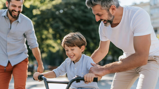 Gay fathers teaching son riding bicycle, family bonding outdoors, happy childhood moments and parental support
