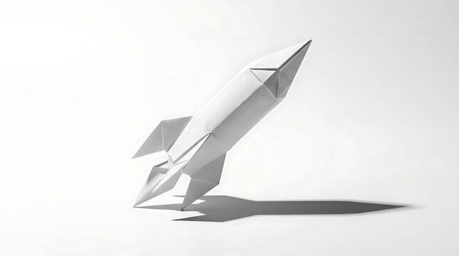 White origami paper rocket launching upward against a minimalist grey background