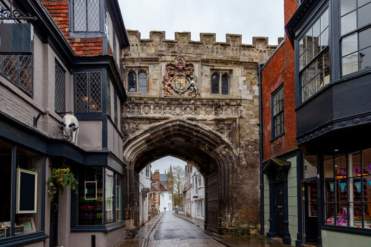 Historic high street gate entrance leading to salisbury cathedral grounds on a rainy day