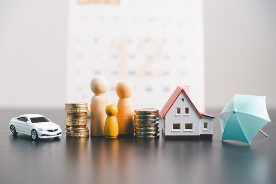 Family figures with a house, car, coin stacks and umbrella, symbolizing family insurance, property protection, vehicle coverage, savings, financial security and household risk planning.