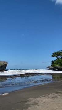 Rugged beach scenery with rocky cliffs and blue skies