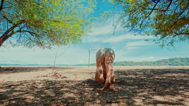 Woman practicing yoga headstand pose outdoors