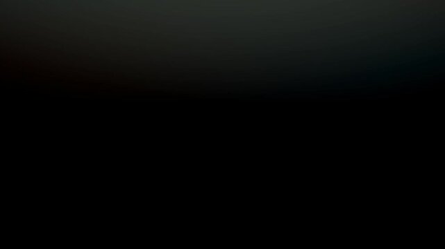 Abstract soft light leak background with warm orange and cool blue gradients on a dark black surface for cinematic overlay and atmospheric visual design.