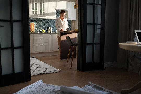 Female architect working in kitchen at home