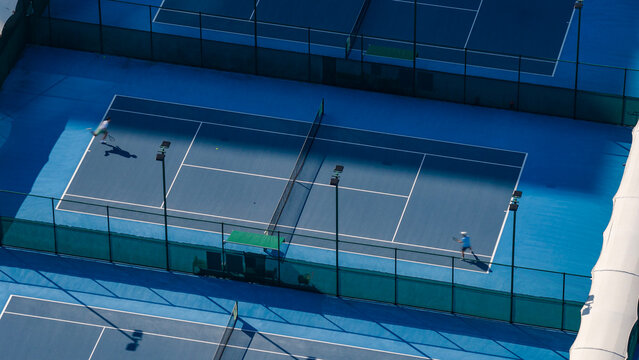 Aerial View of Two Players Competing on Blue Tennis Court