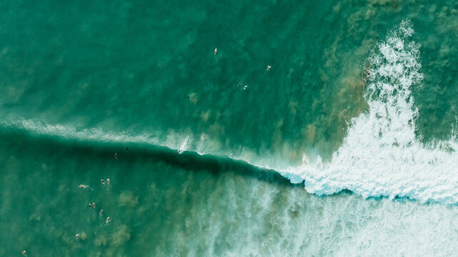 Aerial view of ocean wave and surfer in Puerto Rico