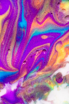 Vibrant marbled paint texture with flowing abstract colors