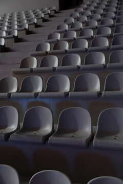 Rows of empty seats in a dark auditorium