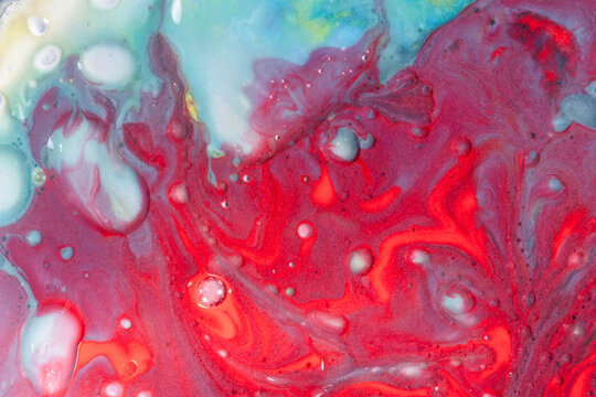 Vibrant red and turquoise fluid abstract background texture