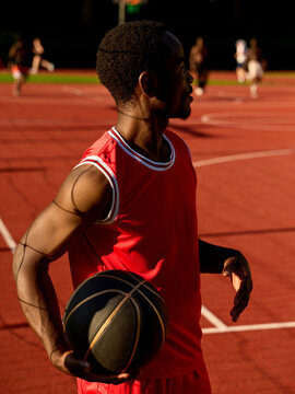 Basketball Player Prepares for Game on Outdoor Court