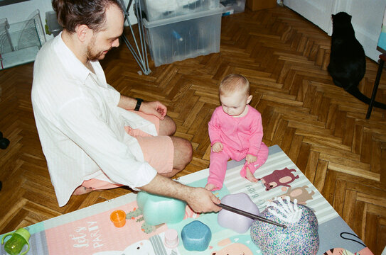 Father and child play together on the floor