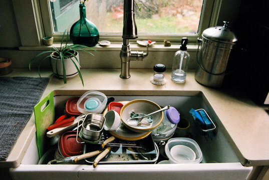 Kitchen sink filled with dirty dishes