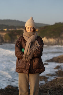 Woman on California coast in warm winter clothing