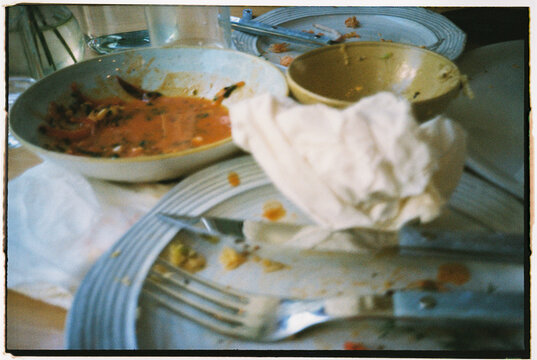 Dinner Leftovers at a Table After a Meal With Friends