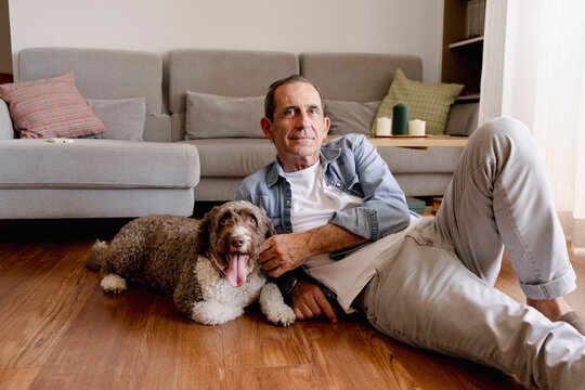 portrait Senior man relaxing at home with his dog