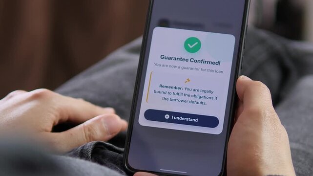 Person confirms guarantor status for a loan on a smartphone, highlighting digital lending, financial responsibility, credit agreements and the legal obligations of modern borrowing.