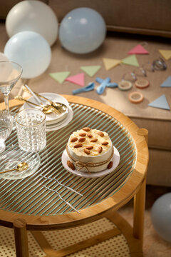 Birthday cake with almonds on a table with party decorations